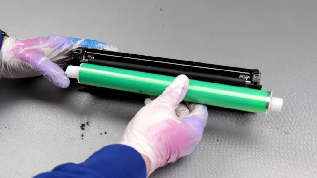 Remove the toner and imaging drum which is a green cylinder